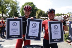 Chimney sweep and son with their guiness world records for completing global bike ride.
